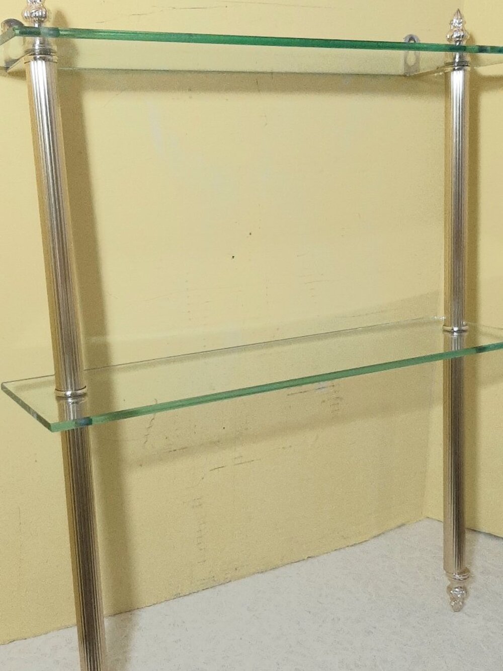 Two tiered glass and gold toned wall shelf
